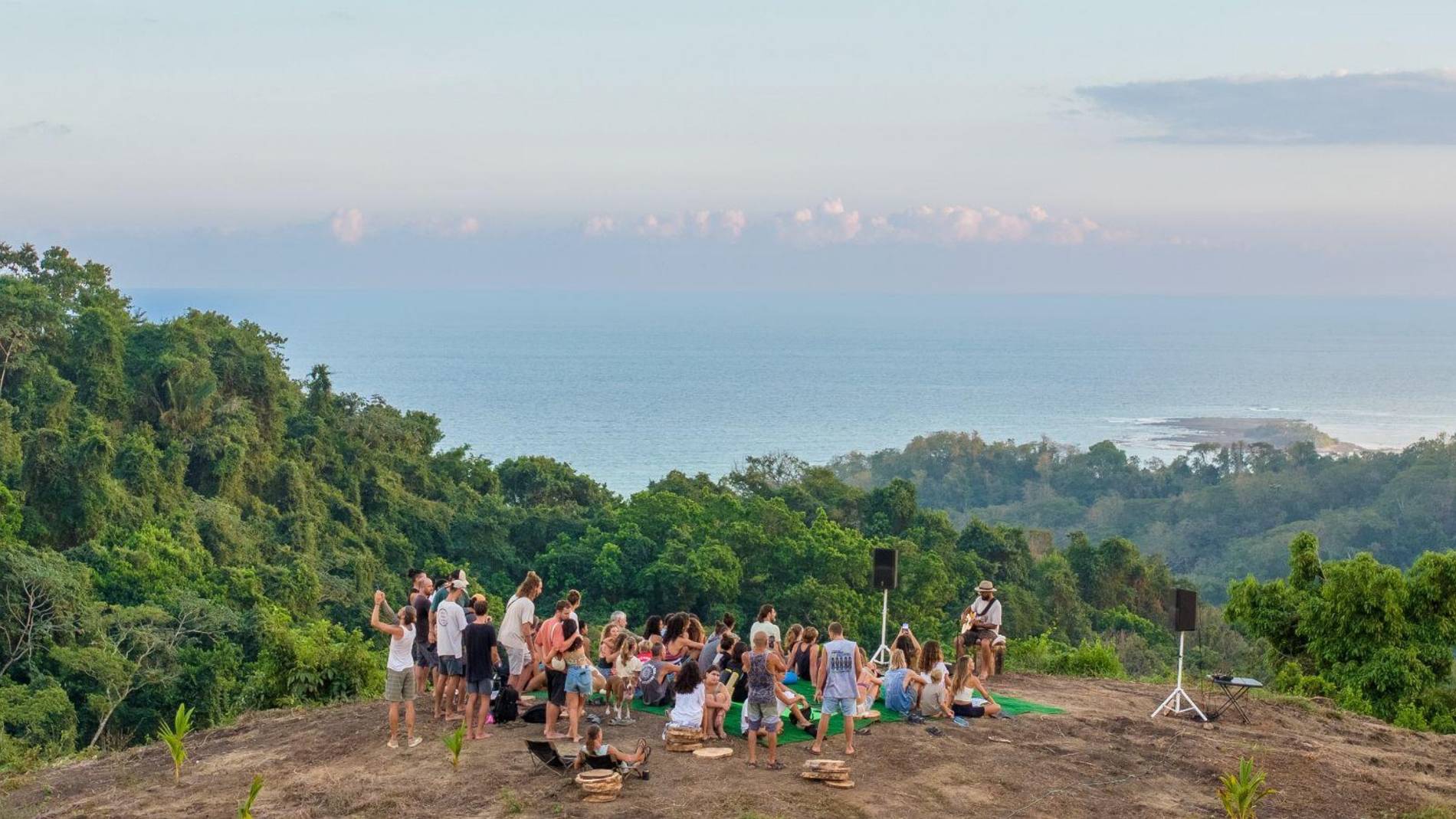 Community gathering at sunset above the Pacific at Beija Flor Village