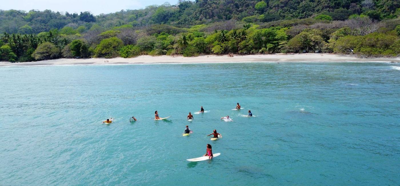 Surfers at the beach near the village